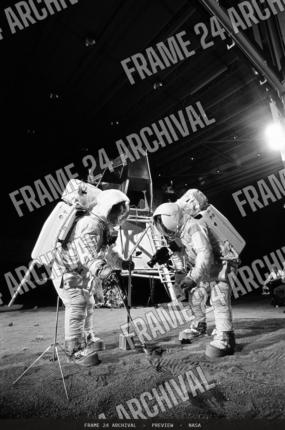 Apollo 11 crewmembers participates in simulation of moon's surface (1969), restored vintage black and white photograph