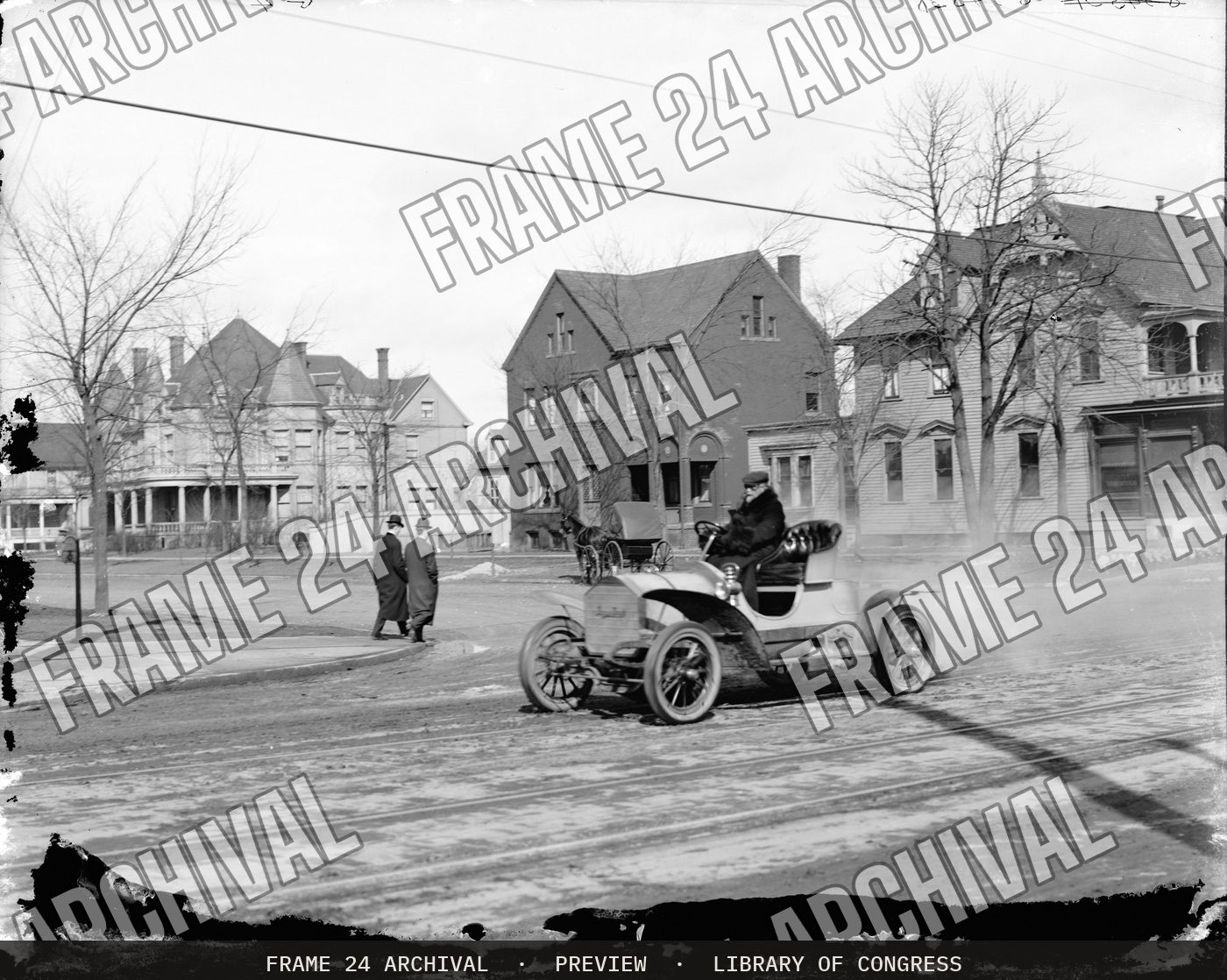 Automobile on town street (1900), restored vintage black and white photograph