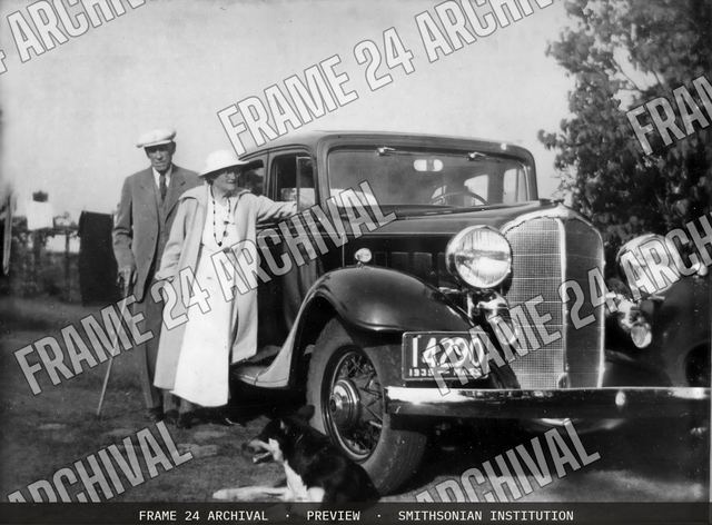 Couple with Car and Dog, vintage black and white photograph