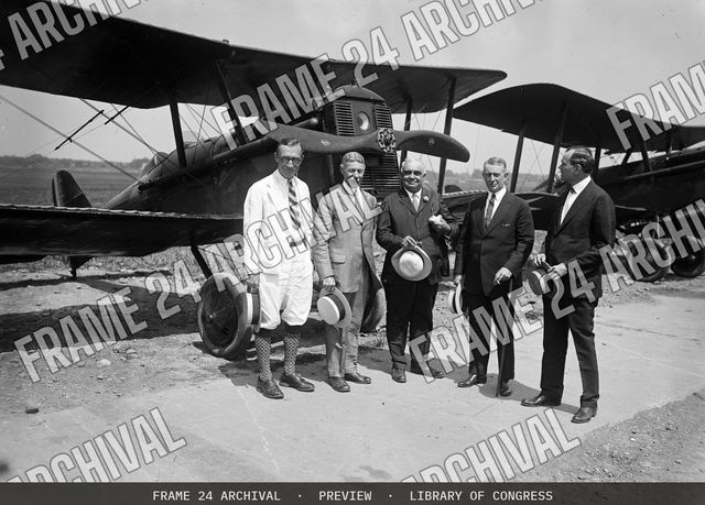 Group at airplane, vintage black and white photograph