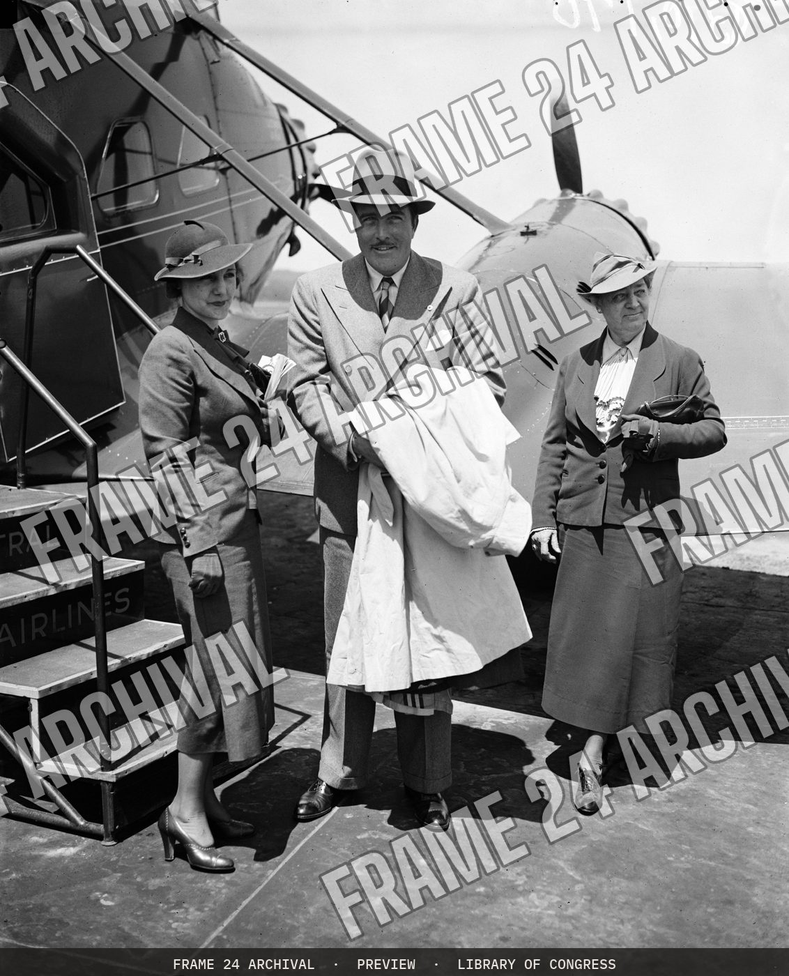 Group at airplane (1936), restored vintage black and white photograph