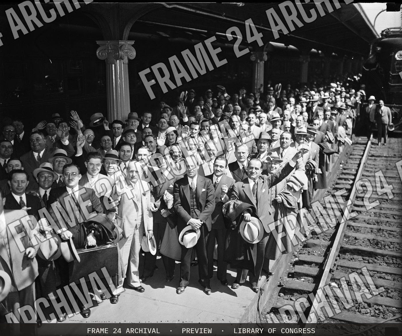 Group at train station (1935), restored vintage black and white photograph