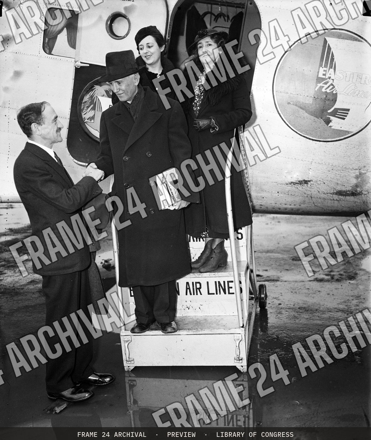 Group exiting airplane (1936), restored vintage black and white photograph