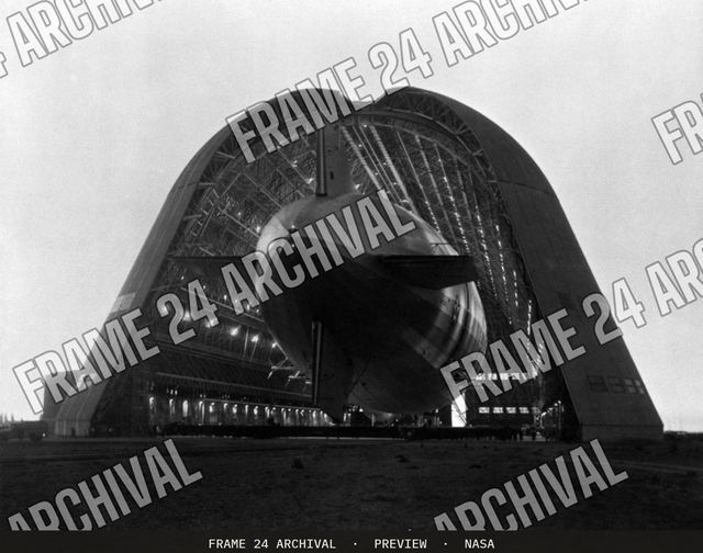 Navy Ridged Airship USS Macon being moved into Hangar 1 NAS Sunnyvale, vintage black and white photograph