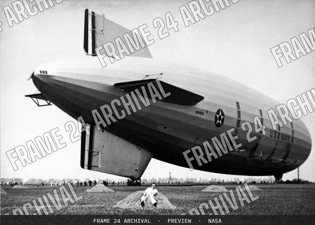 Navy Victor A Hermann in hay next to the USS AKRON. Note lack, vintage black and white photograph