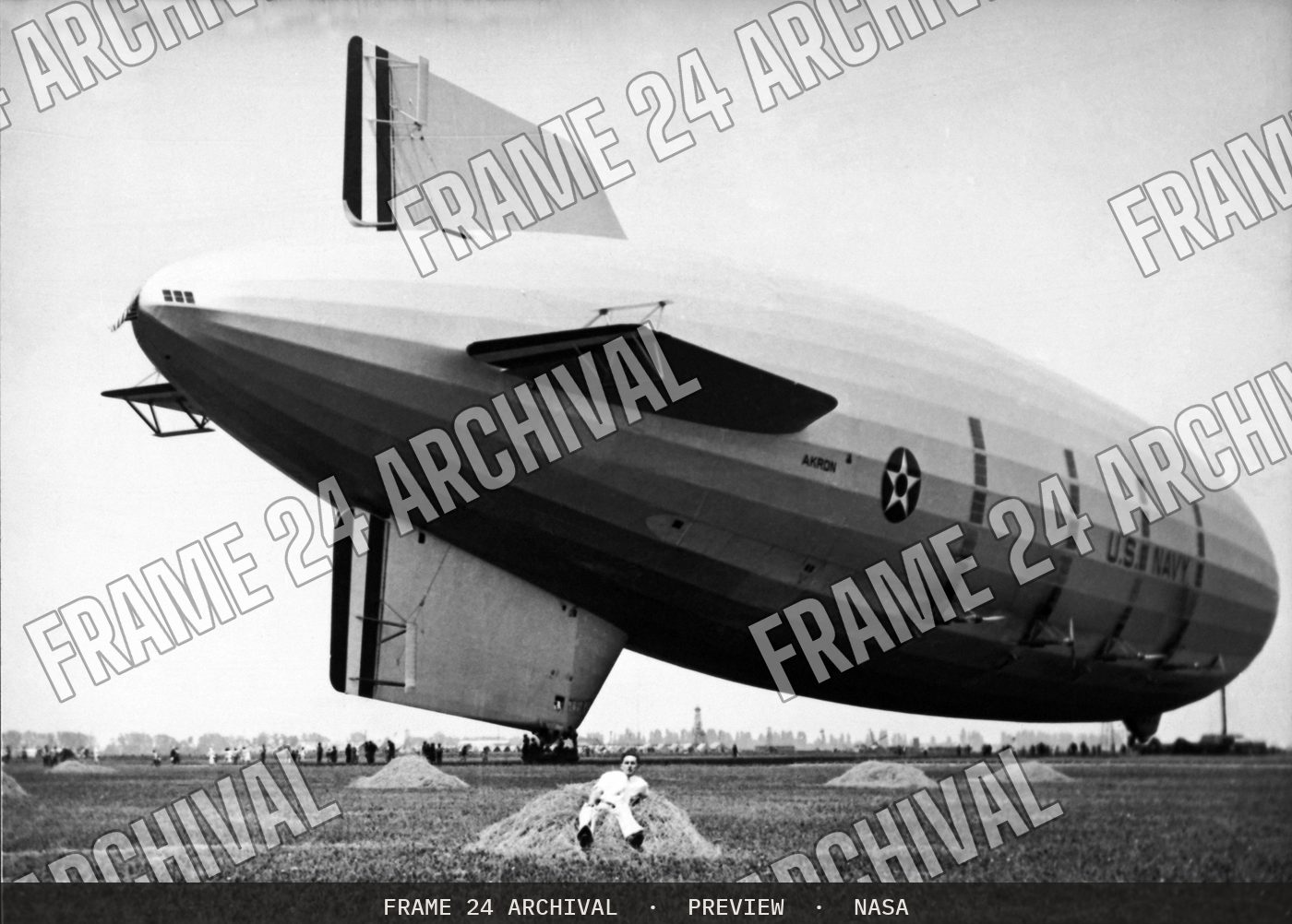Navy Victor A Hermann in hay next to the USS AKRON. Note lack (1932), restored vintage black and white photograph