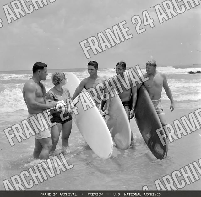 Surfing--Captain Rodney Bothelo, 1st Shore Party Battalion, and Miss Elli Vade Bon Cowur, Associate Director USO, judges for the OSO sponsored surfing contest held September 25, 1966, are shown with P, vintage black and white photograph