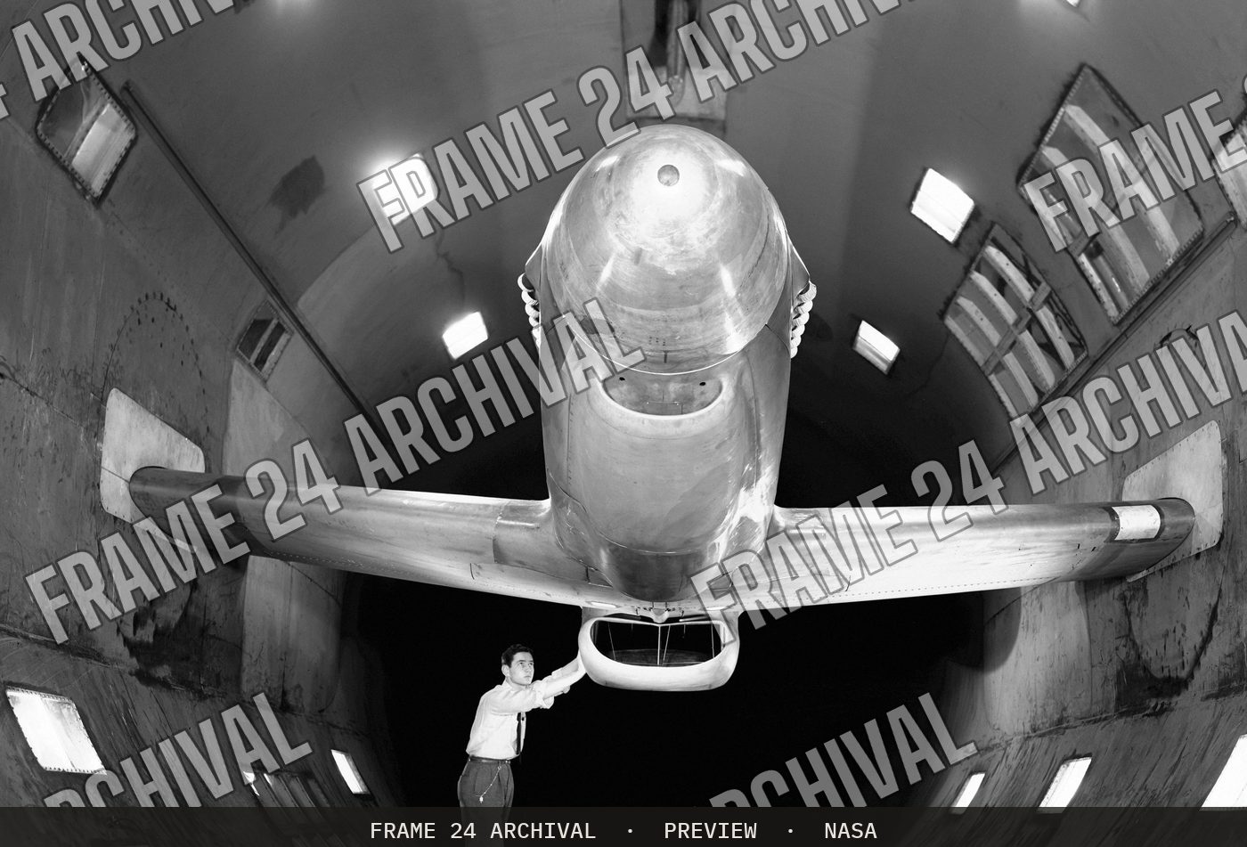 XP-51B airplane in 16ft wind tunnel with test engineer (1943), restored vintage black and white photograph